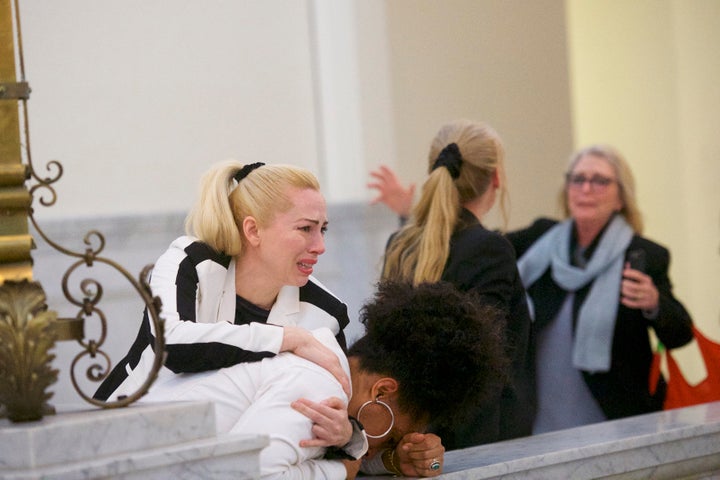 Caroline Heldman (left), Lili Bernard (bowed head) and Victoria Valentino (far right) react after the guilty verdict was delivered.