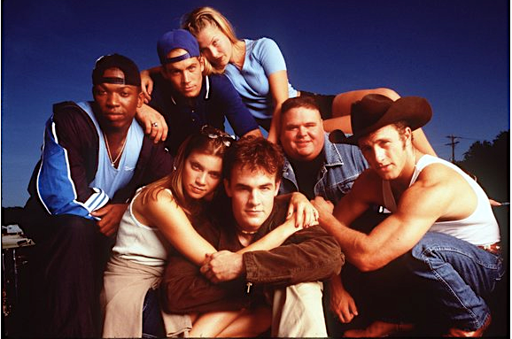 Ali Larter (top) and Amy Smart with James Van Der Beek castmates in 1999's "Varsity Blues."