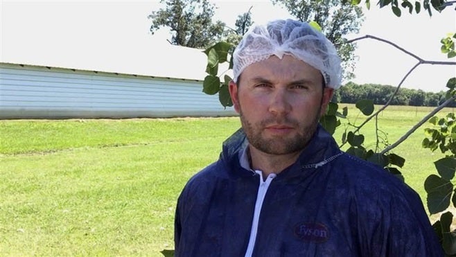 A Tyson Foods employee outside an Arkansas chicken house. Immigration scanning for new employees is especially common in stat