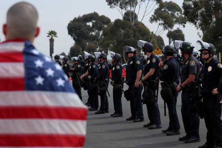 A large police presence watches over protesters and supporters during a visit by President Donald Trump to view border wall prototypes in San Diego on March 13.