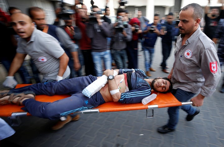 A Palestinian, who was wounded at the Israel-Gaza border, is carried into a hospital in Gaza City, April 27, 2018.