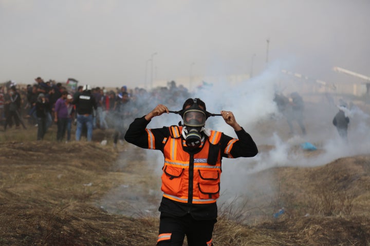 Tear gas canisters are fired by Israeli troops at Palestinian demonstrators during clashes at a protest demanding the right t