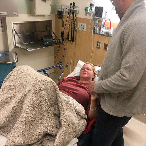 Chris Fischer holds Amy Schumer's hand while she's in the hospital.