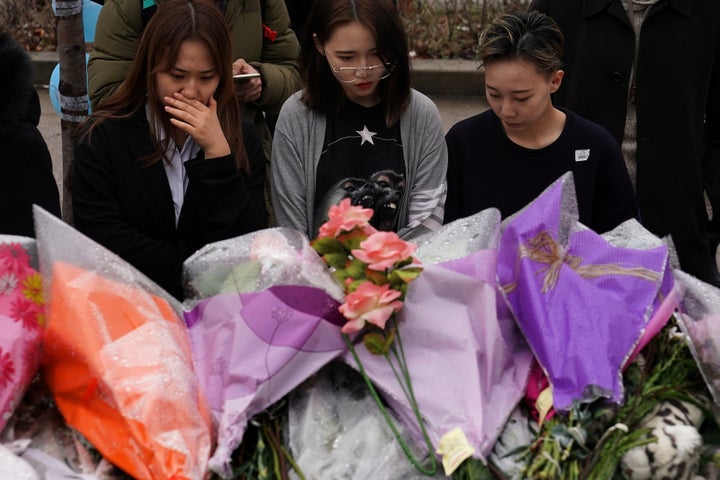 People pay their respects at a makeshift memorial on Toronto's Yonge Street on April 25, two days after the van attack that killed 10 people.