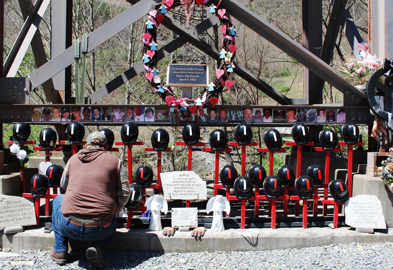 Davis kneels to tend to his son's memorial cross outside Upper Big Branch.