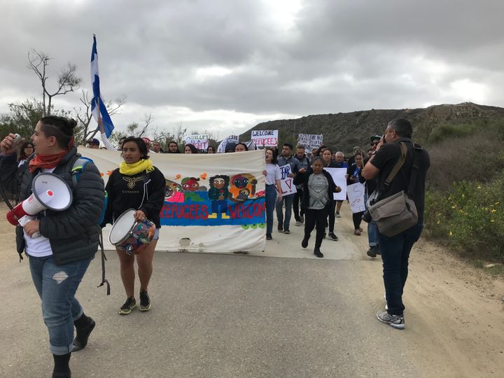 A group of several dozen immigrant rights activists and legal observers march toward the U.S.-Mexico border in San Diego on April 29. They're there to witness the arrival of a caravan of Central American migrants who plan to request asylum in defiance of repeated threats from Trump administration officials.