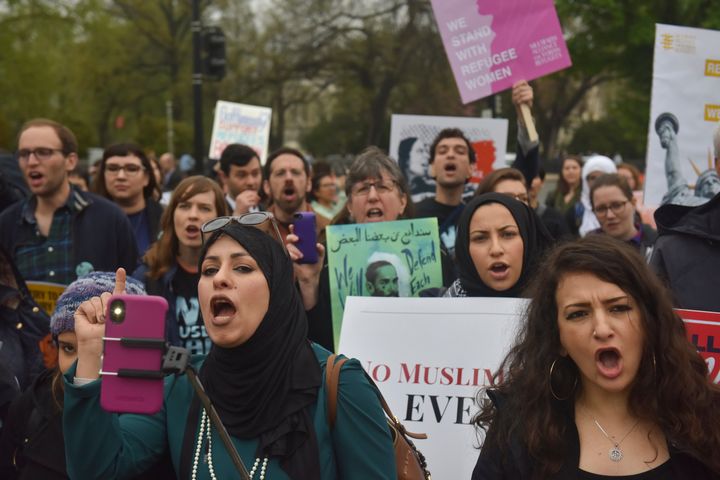 Demonstrators gather outside the United States Supreme Court as the court hears a case involving the travel ban on April 25.