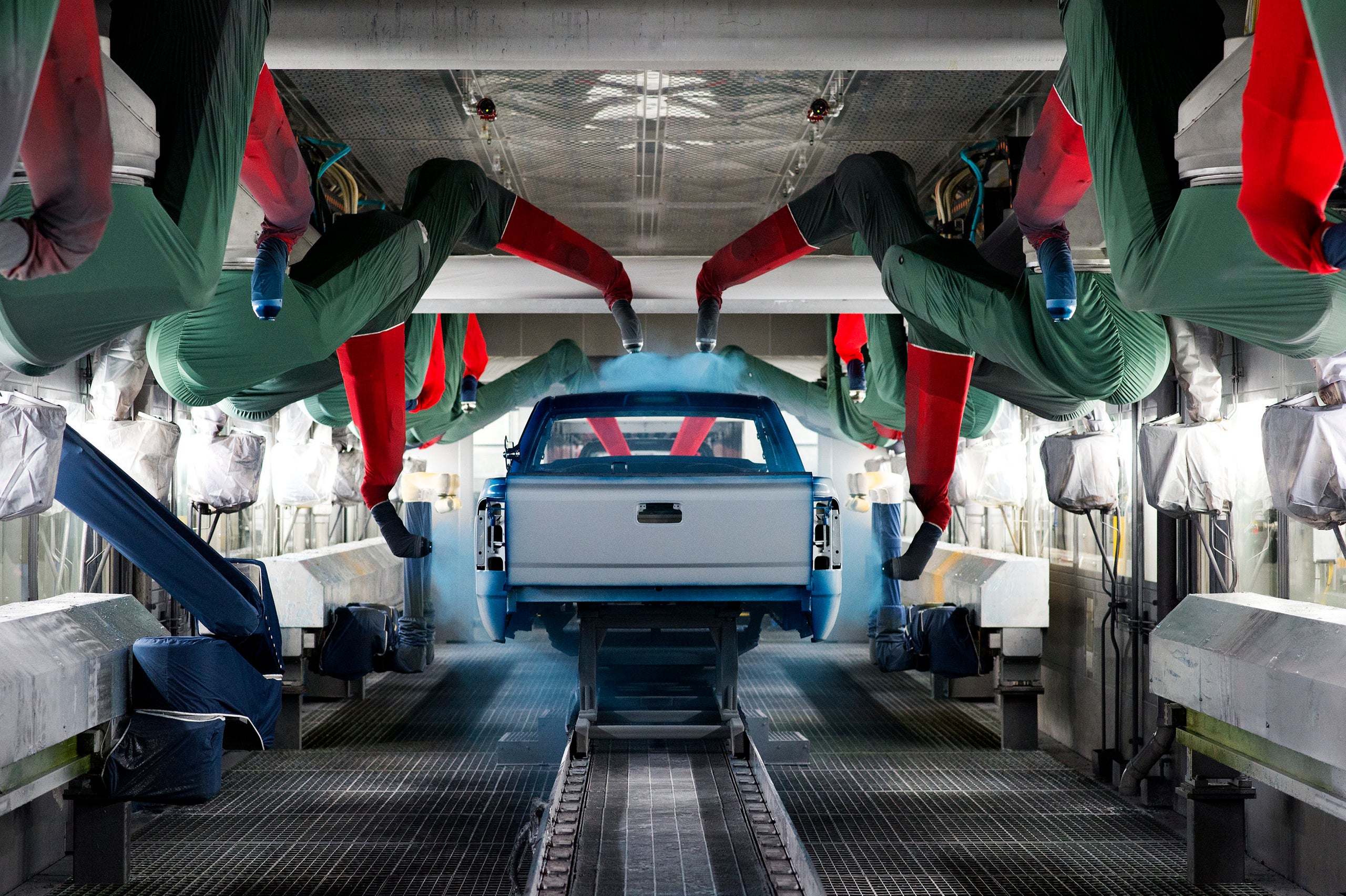Machinery sprays paint on a pickup truck at GM’s assembly facility in Flint, March 23. The base coat is applied by