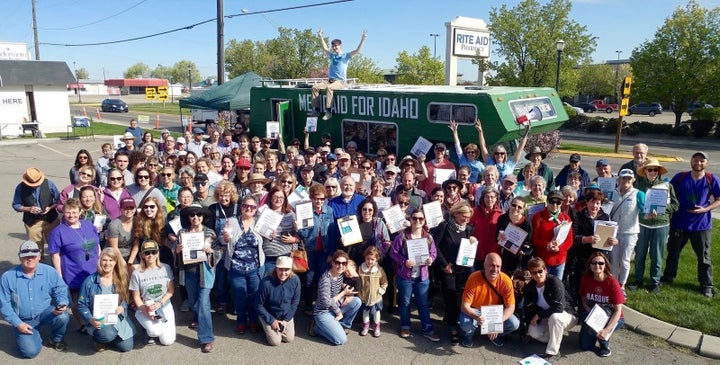 Reclaim Idaho volunteers in Canyon County display signed petitions supporting a ballot initiative for Medicaid expansion whil