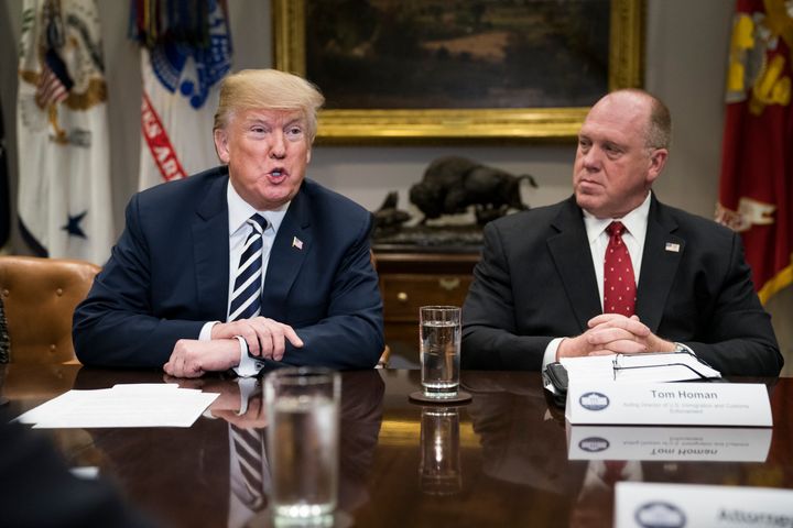 President Donald Trump and acting director of Immigration and Customs Enforcement Thomas Homan talk during a law enforcement roundtable on sanctuary cities in the Roosevelt Room at the White House on March 20, 2018.