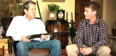 Republican Brian Kemp points a shotgun at "Jake" on his political ad for the Georgia governor's race.