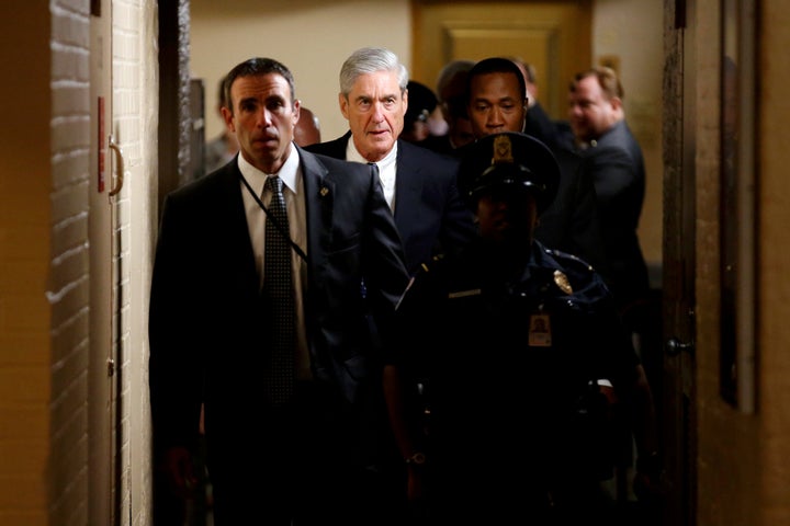 Special counsel Robert Mueller is surrounded by police and security after briefing members of the Senate on his Russia investigation last year.