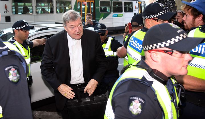 Vatican finance chief Cardinal George Pell (C) arrives in court under a heavy police presence in Melbourne on May 1.