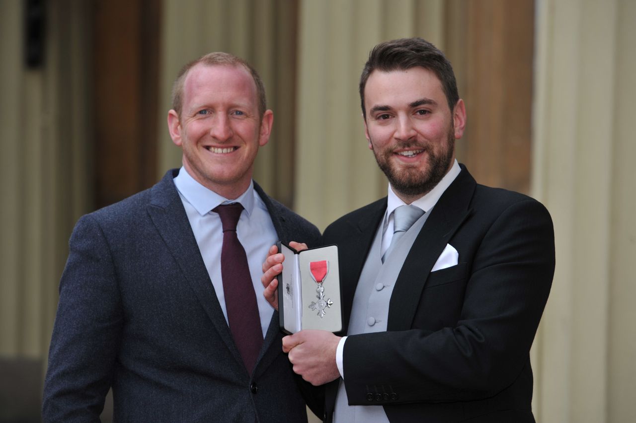 Benjamin getting his MBE, with Laybourn supporting him.