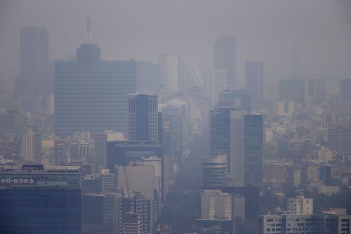 Buildings stand shrouded in smog in Mexico City, March 16, 2016.