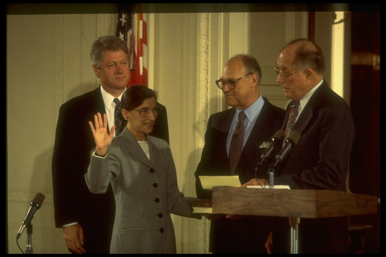 Chief Justice William Rehnquist (right) swears in Ginsburg to the Supreme Court in 1993 as husband Marty (center) and President Bill Clinton look on.