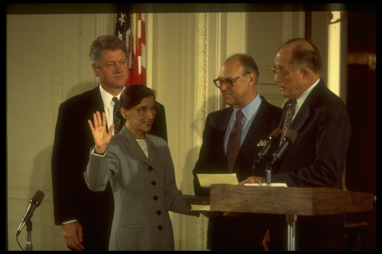 Chief Justice William Rehnquist (right) swears in Ginsburg to the Supreme Court in 1993 as husband Marty (center) and President Bill Clinton look on.