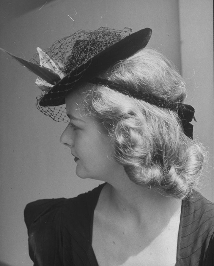 A woman wearing a doll hat, circa 1930s. 