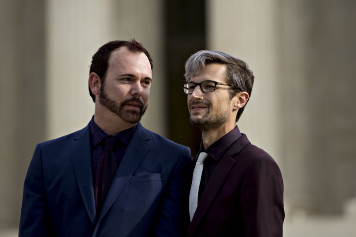 David Mullins (left) and husband Charlie Craig wait to speak to supporters after U.S. Supreme Court arguments in the Masterpiece Cakeshop v. Colorado Civil Rights Commission case in Washington, D.C. on Dec. 5, 2017.