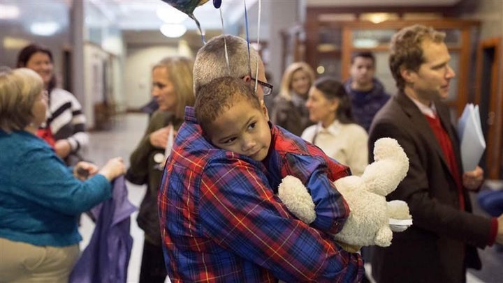 Rich Maynard holds his son, Alden, 3, after Alden’s adoption at the Superior Court in Portland, Maine. Alden was adopted as a foster child. A new federal law completely overhauls the nation’s foster care system. 