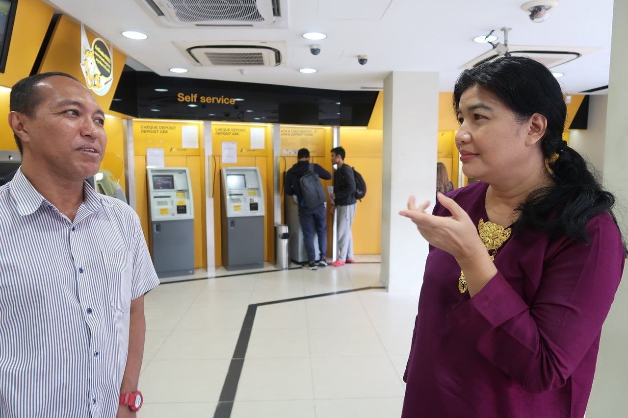 Alzari Mahshar (left) and Tengku Elida Bustaman are volunteers for a fundraising organization to help people vote.