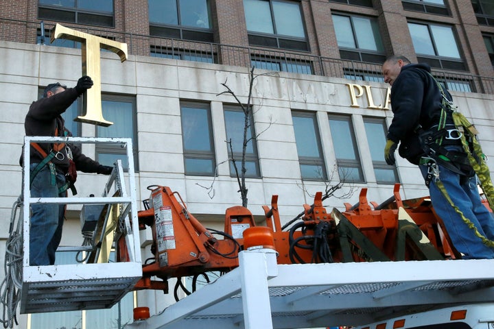 Workers remove Trump’s name from a nearby Trump Place apartment building in November 2016.