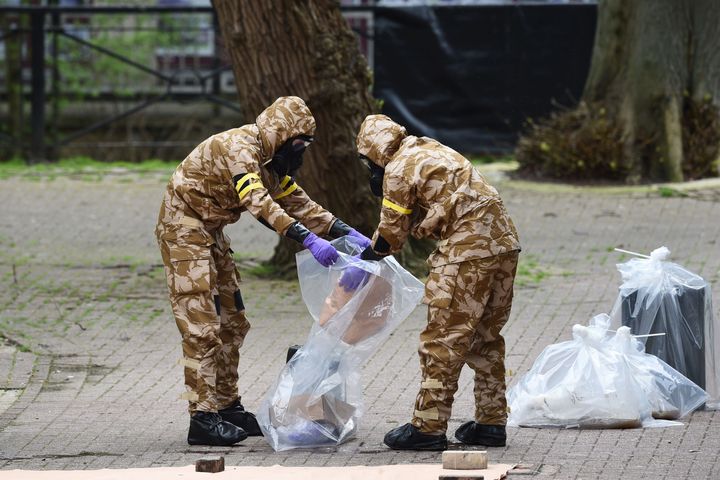 Military personnel place equipment in plastic bags at the site near the Maltings in Salisbury where Russian double agent Sergei Skripal and his daughter Yulia were found on a park bench.