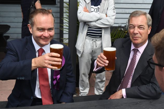 Former Ukip leader Nigel Farage (right) has a pint of beer with Paul Oakley.