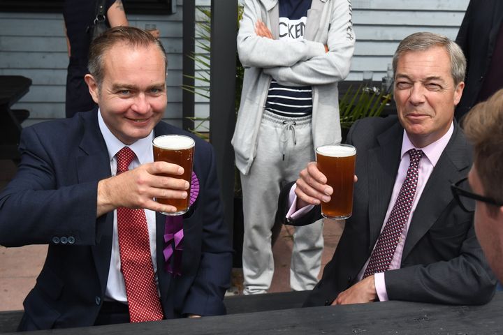 Former Ukip leader Nigel Farage (right) has a pint of beer with Paul Oakley.