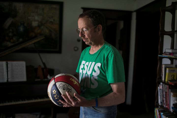Fowle holds a basketball he brought to North Korea at this home in Dayton.