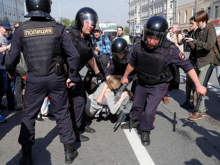Policemen detain opposition supporters during a protest ahead of President Vladimir Putin's inauguration ceremony in Moscow.