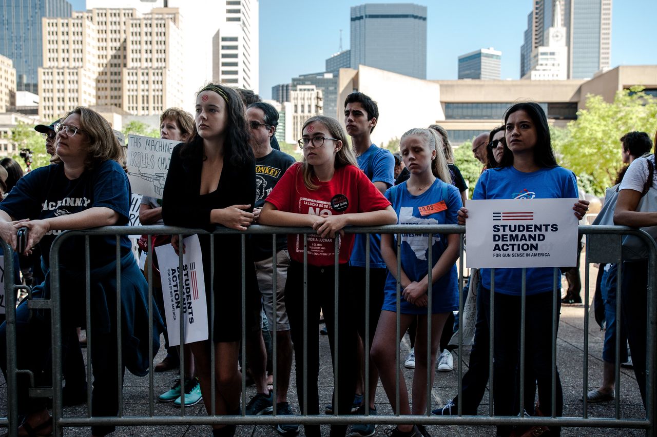Austin, Texas, high school student Julia Heilrayne, second from left, attended the protest with a red target printed on her forehead.