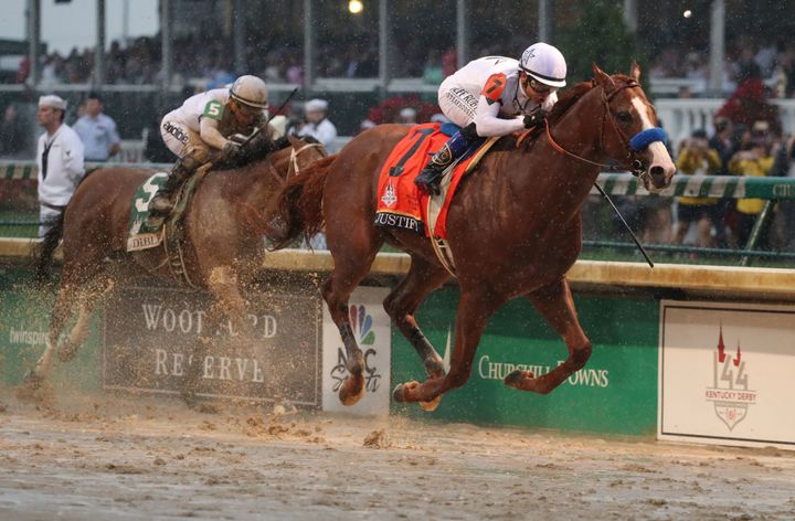 Mike Smith aboard Justify beats Javier Castellano aboard Audible to the finish line to win.