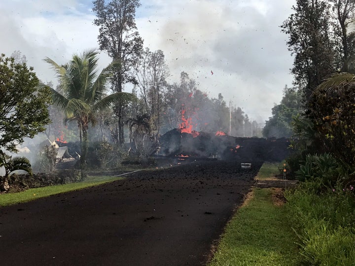 Lava pours across the road at Leilani and Kaupili Streets after the eruption of Hawaii's Kilauea volcano on Friday.