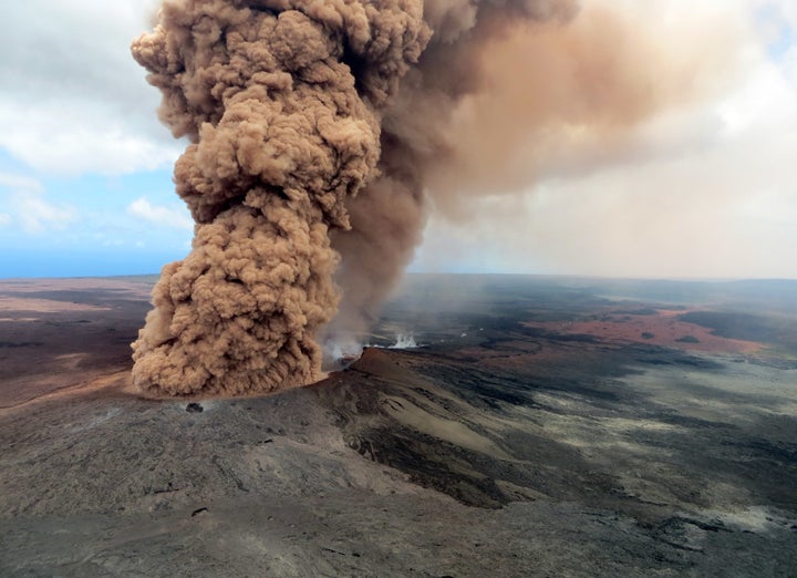 A reddish-brown ash plume blows into the air following the eruption of Hawaii's Kilauea volcano on Friday.