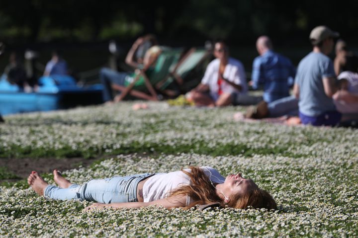 A woman enjoys the sun in Regent's Park London, on Saturday. This weekend's temperatures are set to break records.