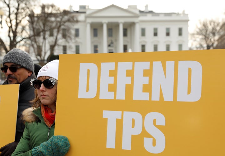 Demonstrators rally outside the White House on Jan. 8 to protest the termination of temporary protected status for Salvadorans. The majority of Americans oppose Trump's immigration policies, according to a new poll.