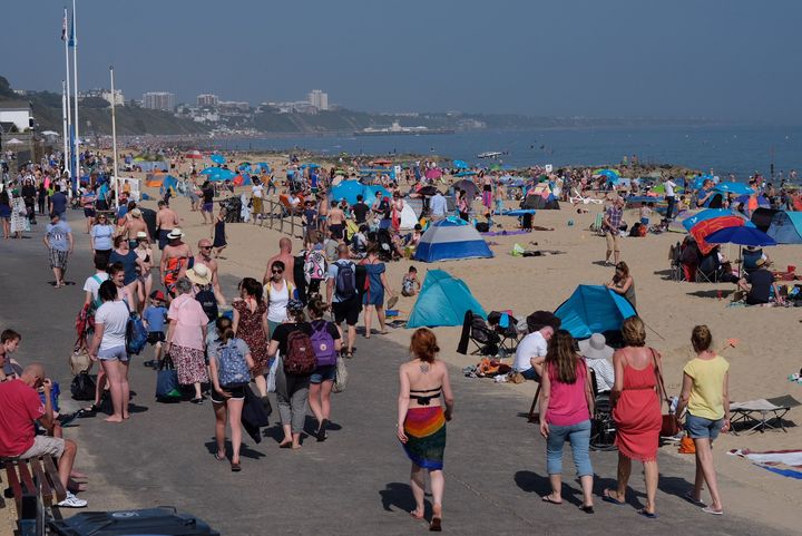 People enjoying the sunshine at Branksome Beach, Poole, as sun worshippers are set to sizzle in the spring heatwave.