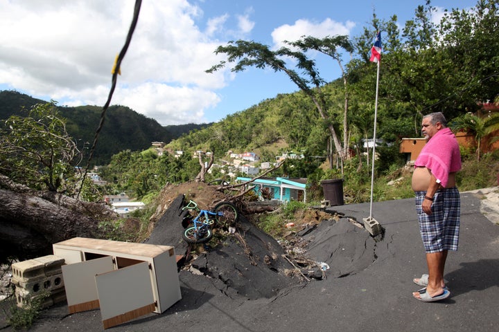 A Puerto Rico resident surveys damage caused by last September's Hurricane Maria.