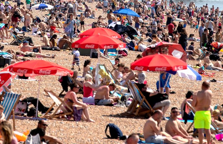 People enjoying the hot weather on Brighton beach.