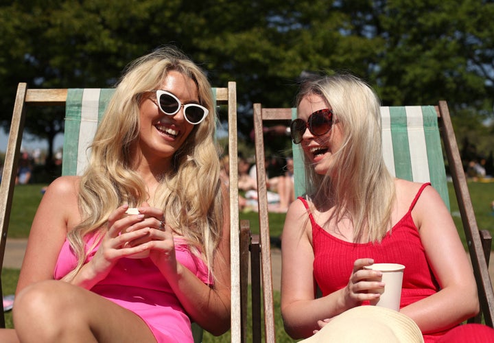 Grainne Gallanagh and Ruth Chalke sunbathing in Hyde Park.