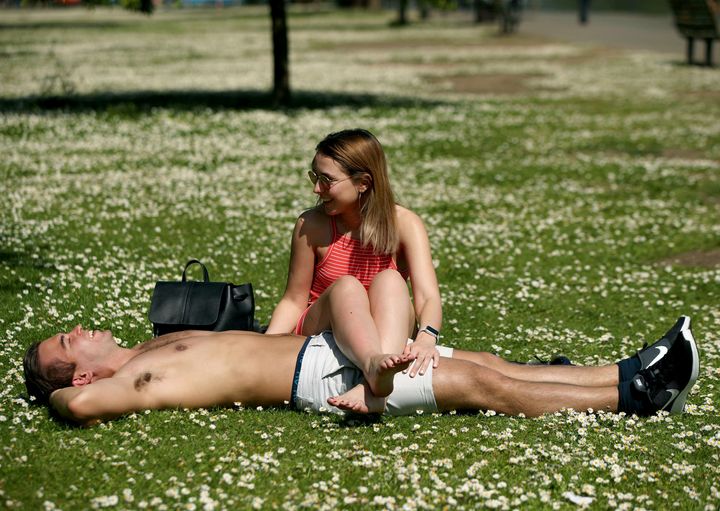 Sunbathers Ruan Opperman and Harriet Curry in Regent's Park, London.