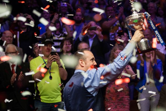 Williams holds his trophy aloft after beating John Higgins