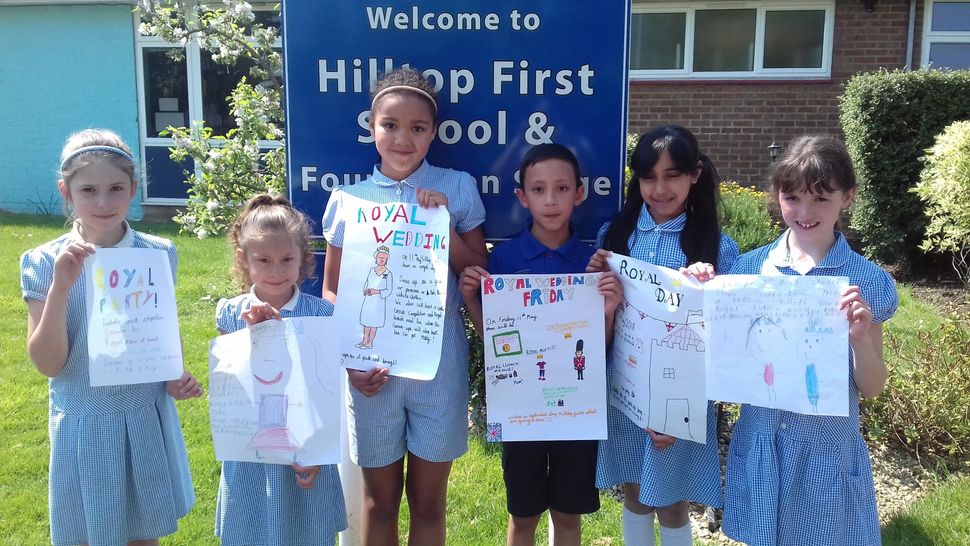 Pupils at Hilltop Primary School with their royal wedding posters. 