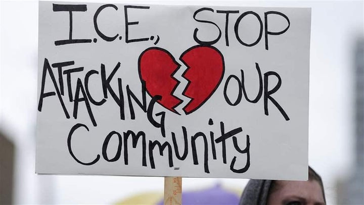 A protester stands outside the Immigration and Customs Enforcement building in Portland, Oregon.