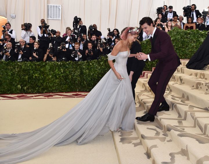 Shawn Mendes makes sure Hailey Baldwin doesn’t trip on her way up the stairs at the 2018 Met Gala.
