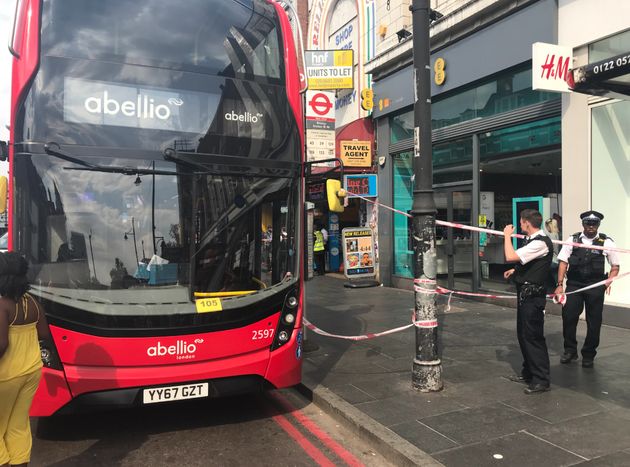 A double-decker bus has been taped off by police following a suspected acid attack in Brixton, south London 