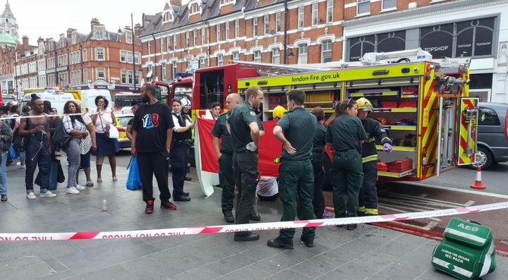 Fire-fighters treat a woman involved in an suspected acid attack 