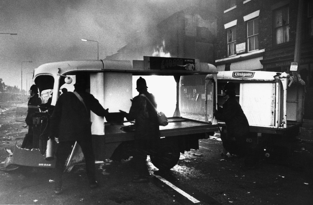 Looted shops burn during the Toxteth riots in 1981.