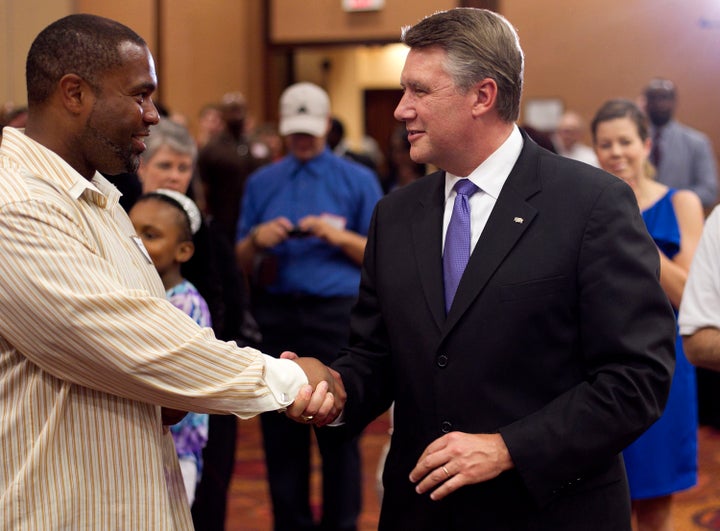 Mark Harris, right, talks with Jahnmaud O. Lane during an election party in Raleigh, North Carolina, on Tuesday.